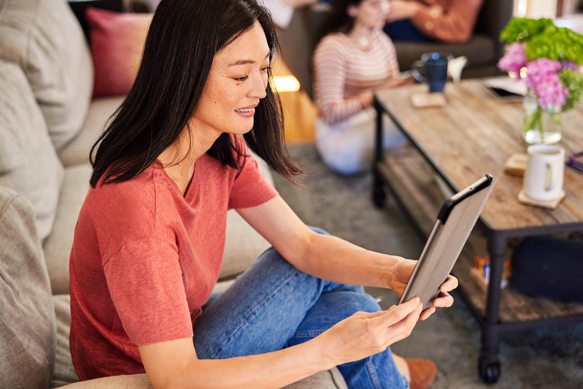 Woman reading from a tablet.