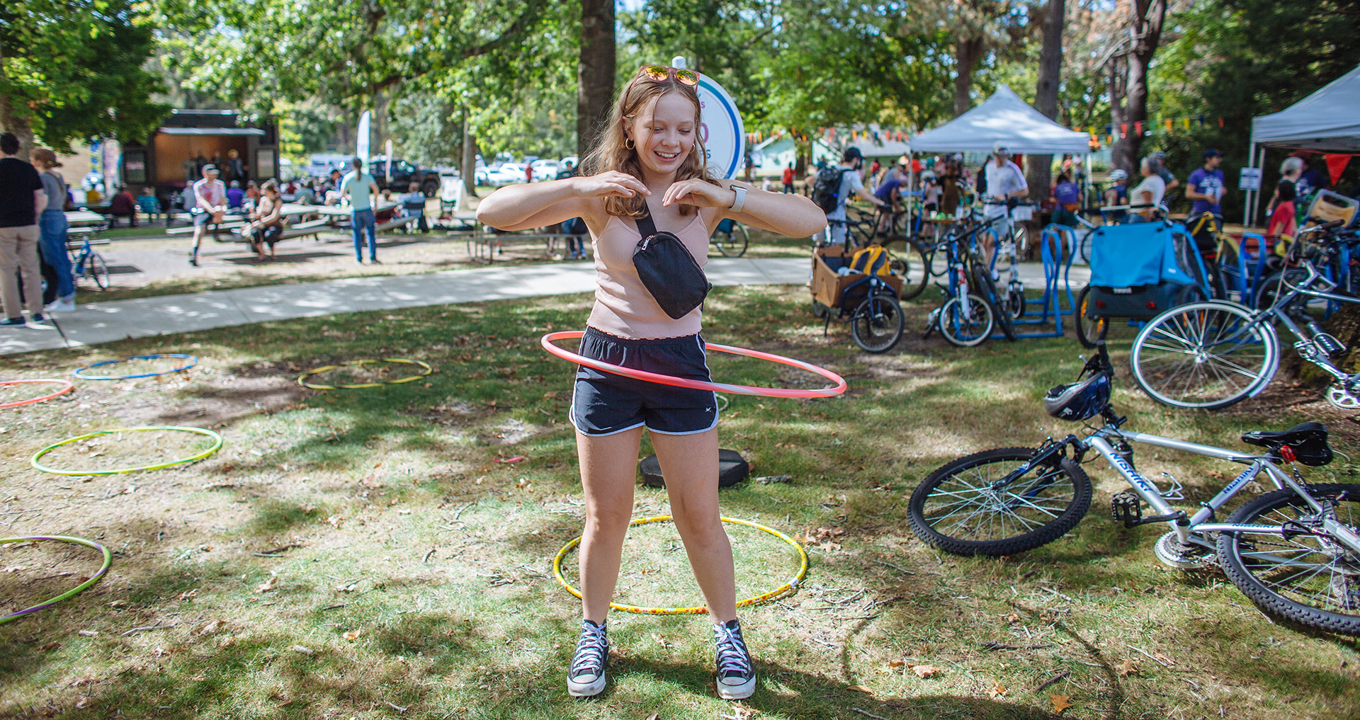 Girl hula hooping at the park.